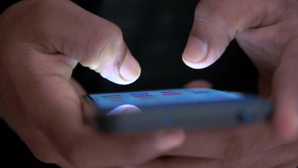 Close Up of Man's Hand Using Smart Phone at Night alt