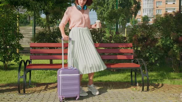 Caucasian Woman with Baggage in Town alt