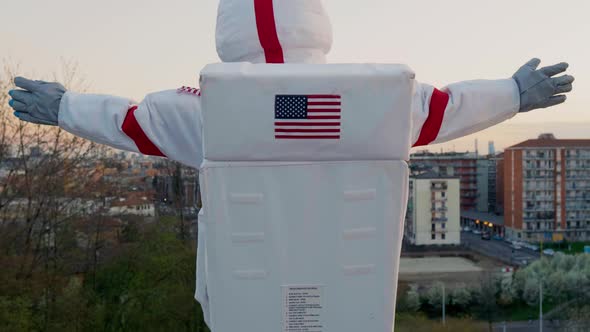Spacewoman standing over city opening arms
