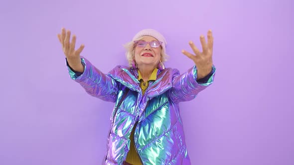 Contented, Fun-loving Older Woman Enjoys Her Charm By Posing for the Camera Against an Isolated alt