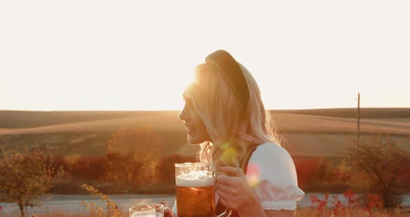 Slavic Lush Girl in Ethnic Dress Poses at Camera with Two Pints of Beer alt