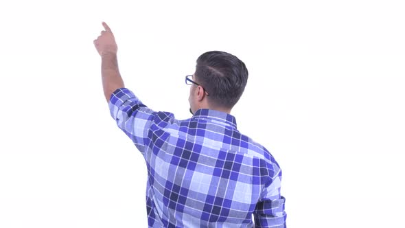 Rear View of Bearded Persian Hipster Man Directing and Pointing Finger alt