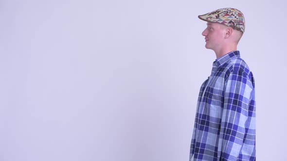 Profile View of Happy Young Handsome Hipster Man Pointing Finger alt