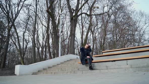Girl sits on bench in the park alt