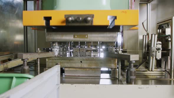 A large industrial punch press forming sheet metal parts alt