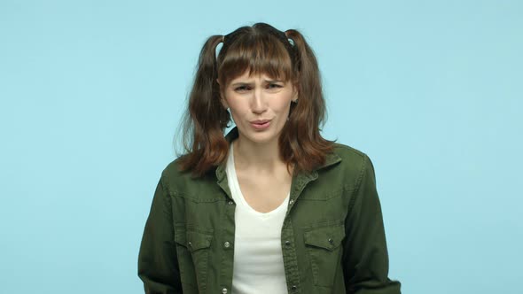 Slow Motion of Worried Young Woman with Funny Double Ponytails Hairstyle Shaking Head and Hands