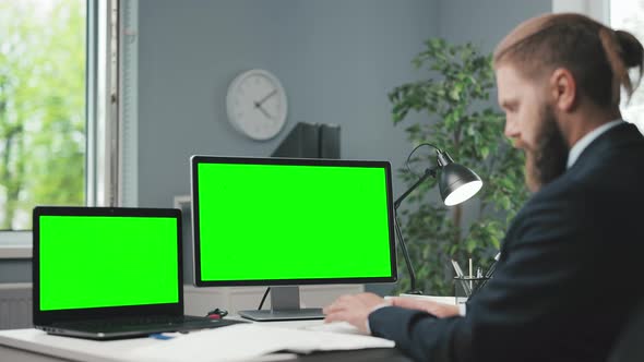 Man Using Green Screen Computers