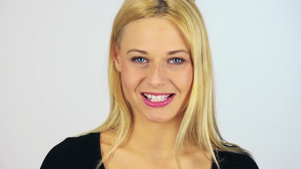 A Young Attractive Woman Talks To the Camera with a Smile - Face Closeup - White Screen Studio alt
