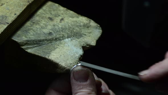 Closeup of Wedding Ring Polishing By Caicasian Jeweler Isolated  Footage alt