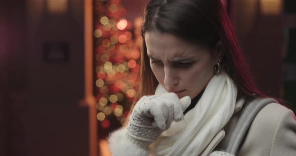 Young woman coughing.