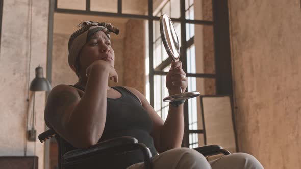 Handicapped Woman Looking in Mirror alt