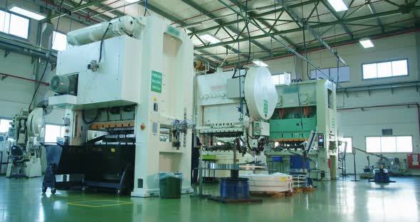 Close up shot of a punch press forming metal parts alt