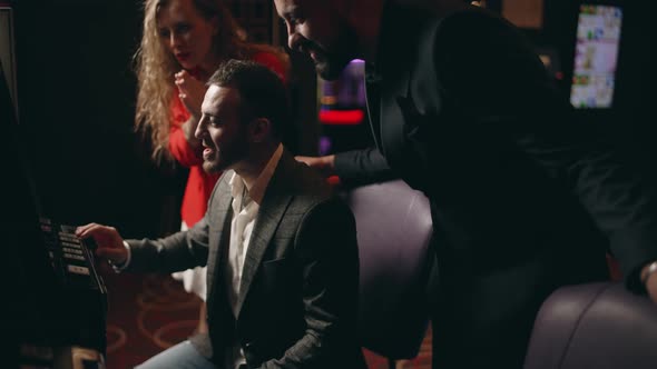 Group of Young People are Rejoice in Victory the Jackpot in a Slot Machine alt