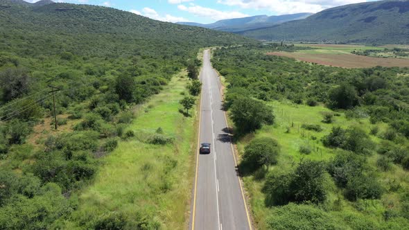 Aerial View of Car Driving Along Scenic Nature of Limpopo Province at South Africa
