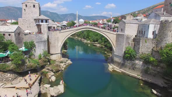 People on the bridge in Mostar waiting for jumping to start alt