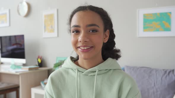 Happy Gen z Teen Girl Waving Hand Talking To Camera in Bedroom alt