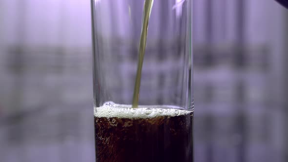 Dark Soda Is Poured Into a Glass From a Plastic Bottle, Close Up, Movement Up alt