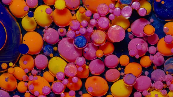 Top View Movement of Pink Oil Ink Drops Bubbles Multicolored Artistic Paint Surface Background alt