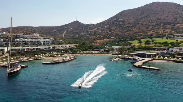 Aerial View of a Jet Ski Boat in a Deep Blue Colored Sea. Spinalonga Island, Crete, Greece