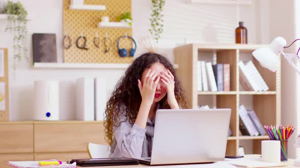Asian woman working on computer at home. Casual concentrated entrepreneur developing new project whi alt