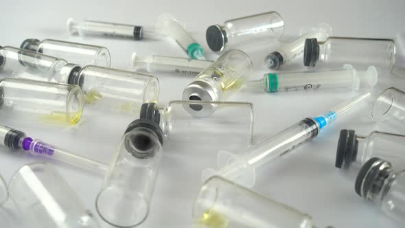 Syringes and ampoules on a white background. alt