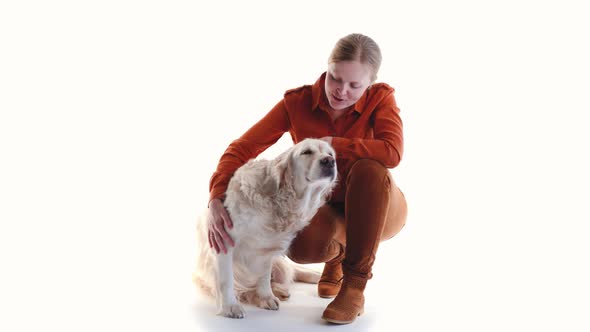 Love for Pets. Studio Portrait of a Woman and Golden Retriever in Studio on a White Background.
