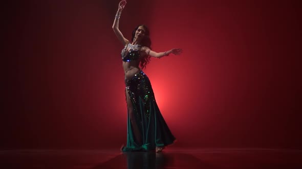 Torso of Belly Dancer Dancing Belly Movement Modern . Red Smoke Background. Slow Motion alt