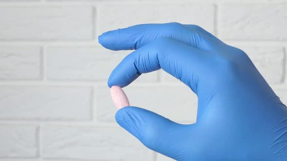 The Hand of a Medical Worker Chooses Pills
