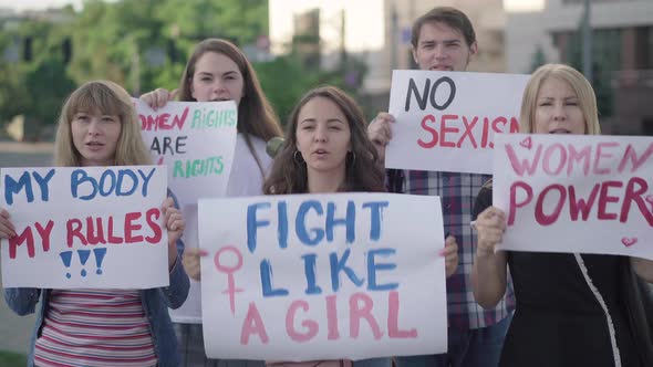 Five Caucasian People Shouting And Holding Feminism Banners With Slogans Portrait Of Men And 