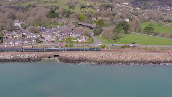 Commuter Train Alongside the Sea Aerial View alt