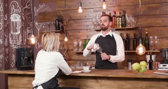 Bartender Telling a Story To His Coworker After Work alt