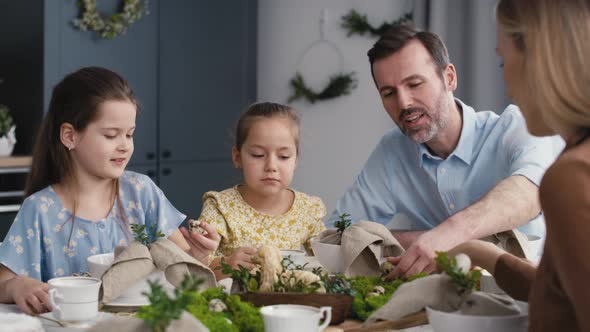 Caucasian family of five spending time over table on easter time. Shot with RED helium camera in 8K. alt