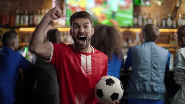 Football Fans of Different Races Drink Beer and Watching a Football Match at the Bar Fan of the alt