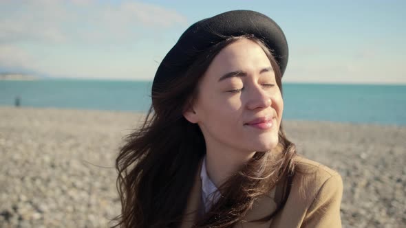 Charming Girl Enjoys Day on a Beach alt