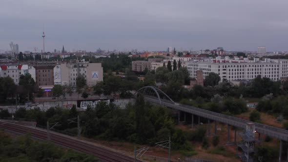 Fly Above Railway Tracks and Road Bridge in City alt