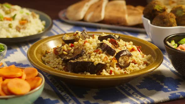 Sprinkling Pepper on Bulgur with Eggplant Closeup Couscous with Meat on Background alt