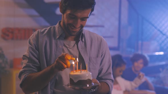 Man Lighting Candles on Cupcake alt