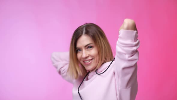 Woman in Casual Clothes Dancing on Color Background