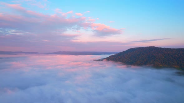 4K Drone Flying in the clouds. Flying through the clouds during sunrise alt