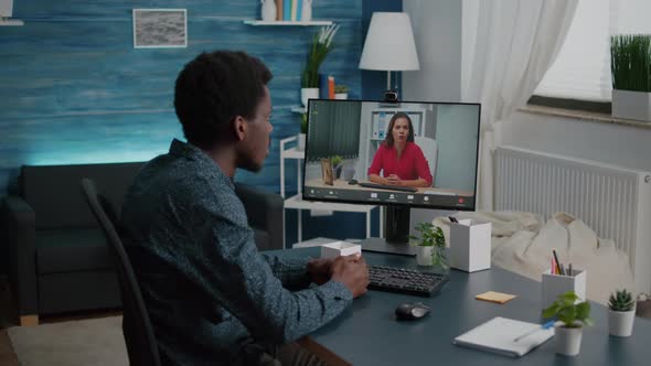 Zoom in Shot on Black Man Remote Working Talking with Boss Via Online Webcam alt