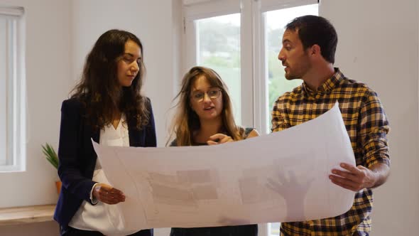 Millennial creative professionals working in a creative office alt