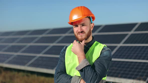 The Engineer is Standing and Looking at the Camera alt