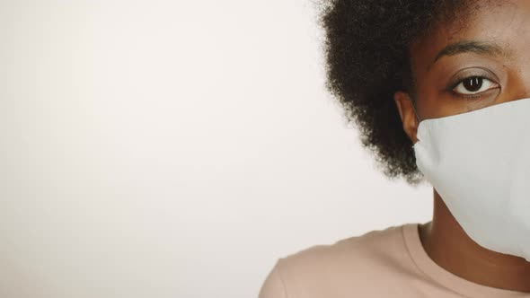 Half Face of Black Woman in Protective Face Mask alt