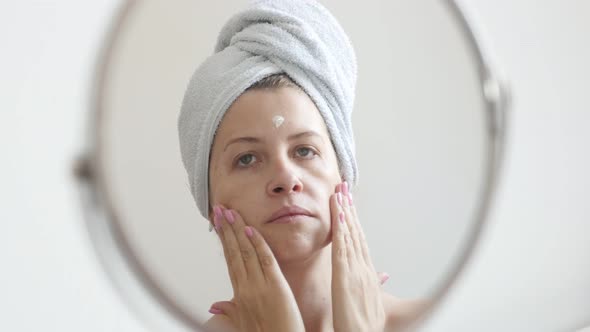 Beautiful  Caucasian female in front of make-up mirror 4K 2160p 30fps UltraHD footage - Woman applyi alt