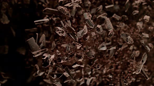 Super Slow Motion Shot of Raw Chocolate Chunks and Cocoa Powder After Being Exploded at 1000Fps. alt