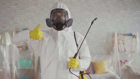 Exterminator Shows His Thumb Up and Looks Into the Camera alt