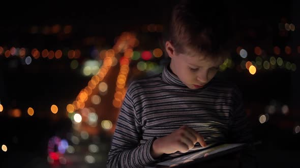 Boy Playing on a Tablet alt