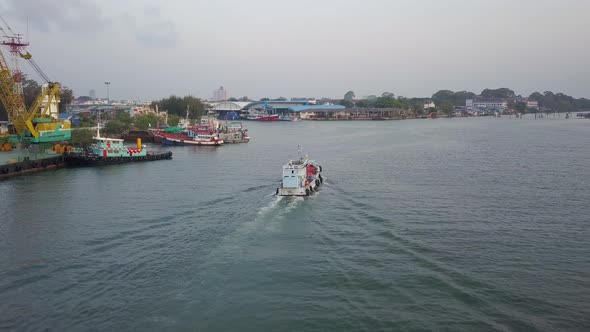 Fishing Boat Sailing Across The Sea And Passing By The Port Of Rayong In Thailand. aerial alt