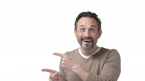 Happy and Cheerful Excited Mature Father with Beard Grey Hair Pointing Fingers Left at Corporate alt