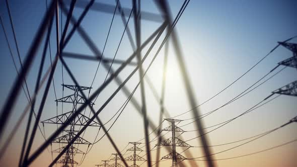 Endless electric powerlines and pylons loopable animation on a cloudless sky. HD alt